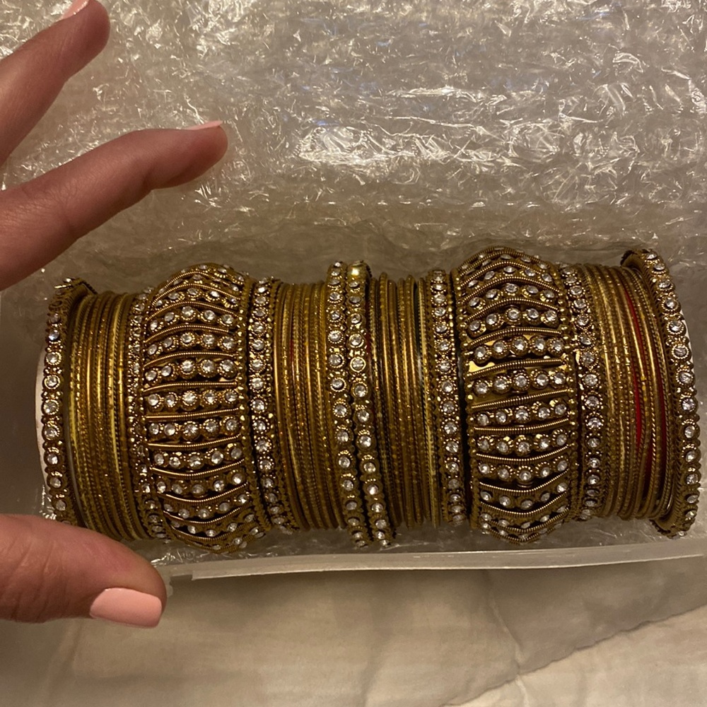 Stack of Gold bracelets with crystals